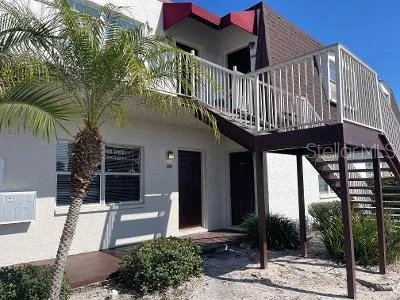 a view of a patio with couches table and chairs and potted plants