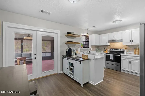 a kitchen with a stove and a refrigerator
