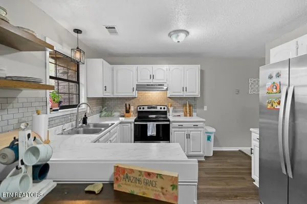 a kitchen with a sink stove and cabinets