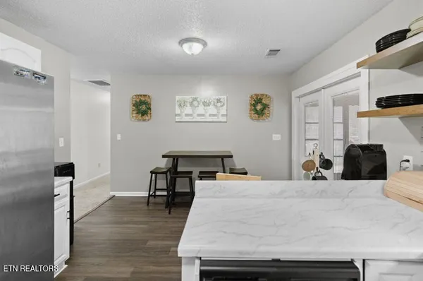 a kitchen with stainless steel appliances a refrigerator and a stove