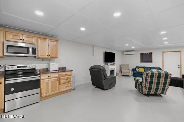a bedroom with furniture and a flat screen tv