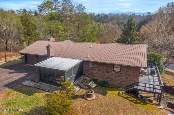 a view of a backyard with a barn and a fire pit