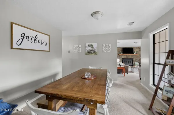 a kitchen with stainless steel appliances granite countertop a stove top oven a sink dishwasher and a refrigerator with wooden floor