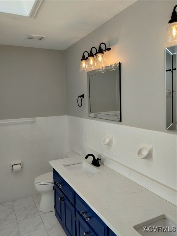 3249 Maidens Road Powhatan, VA 23139 - Photo 24 of 45 Bathroom with marble look tiles, toilet, a wainsco