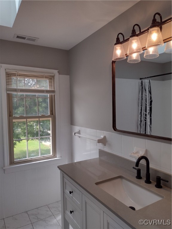 3249 Maidens Road Powhatan, VA 23139 - Photo 29 of 45 Bathroom with marble look tiles, vanity, wainscoti