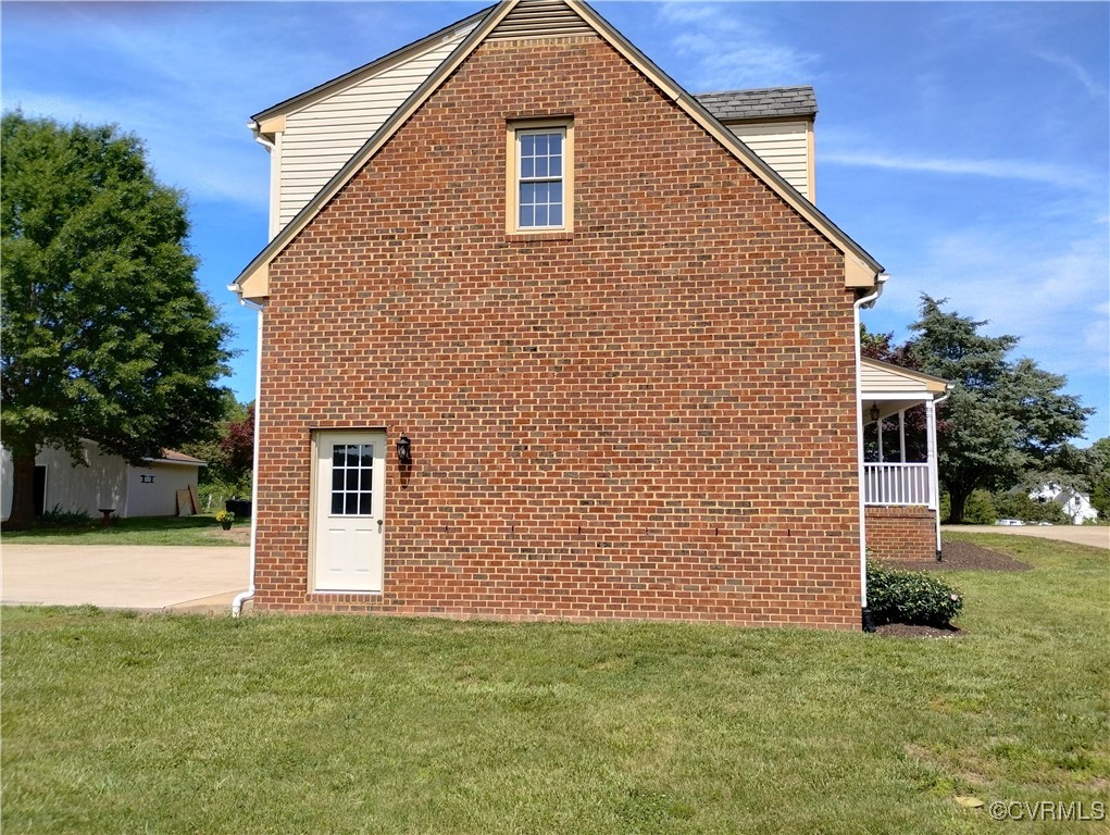 3249 Maidens Road Powhatan, VA 23139 - Photo 6 of 45 View of property exterior featuring a yard and bri