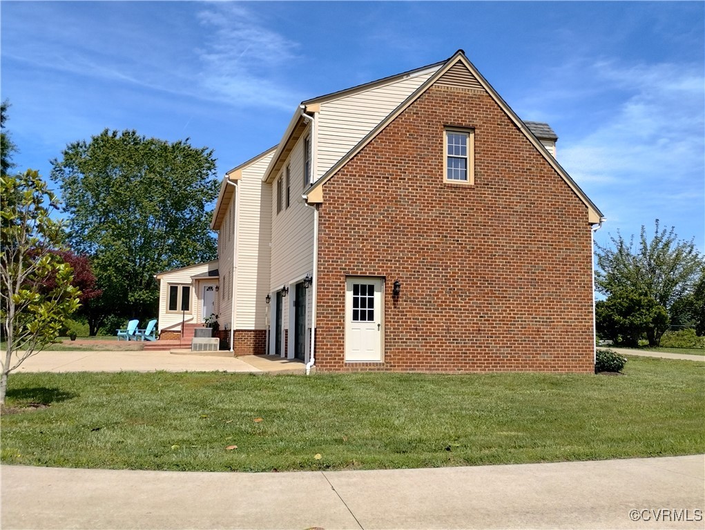 3249 Maidens Road Powhatan, VA 23139 - Photo 7 of 45 View of property exterior featuring a lawn, a gara