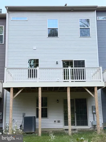 a front view of a house with garage and plants