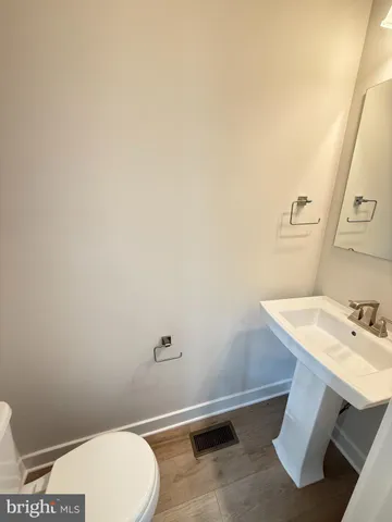 a bathroom with a sink a toilet and vanity