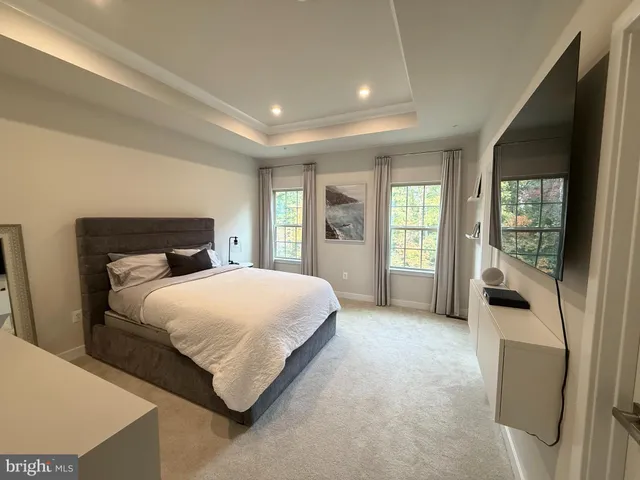 a bedroom with a large bed and a large window