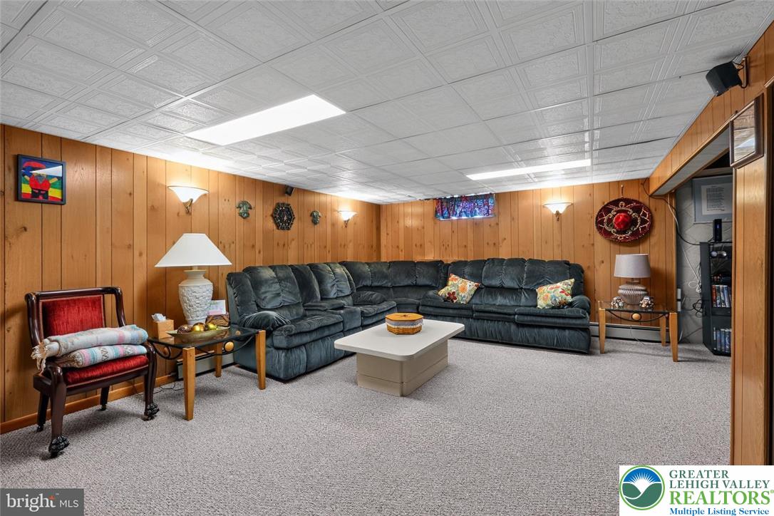 740 Public Road Bethlehem, PA 18015 - Photo 39 of 40 A versatile recreation room featuring paneled walls and comfortable seating, perfect for entertaining.