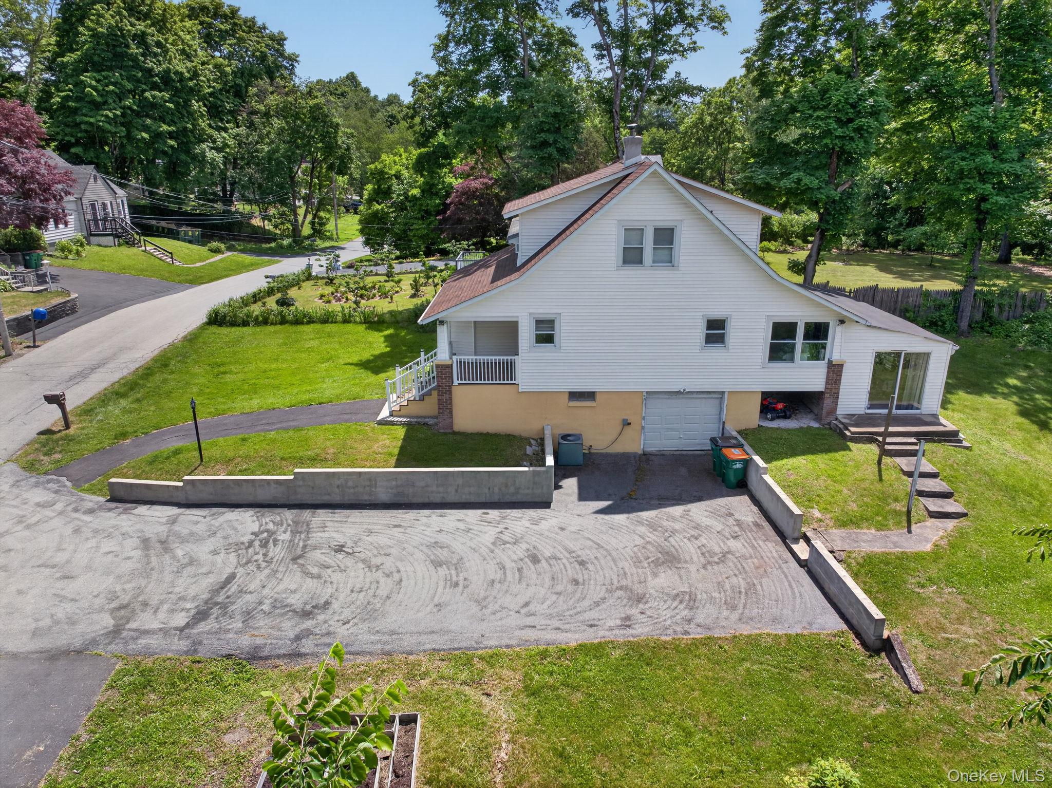 7 Walnut Street Poughkeepsie, NY 12601 - Photo 24 of 30 Side of home with large driveway and surrounding walls.