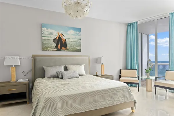 a bedroom with a bed and a chandelier