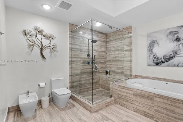 a bathroom with a toilet and a shower