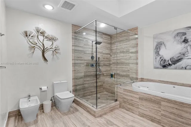 a bathroom with a toilet and a shower