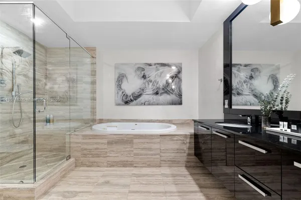 a view of a bathroom with a bathtub and a shower