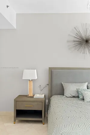 a bedroom with a bed and a night stand