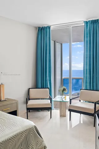 a bedroom with a bed and large window