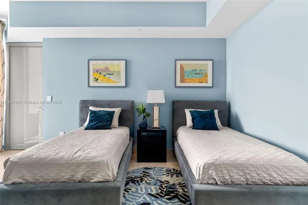 a bedroom with two beds and a couch
