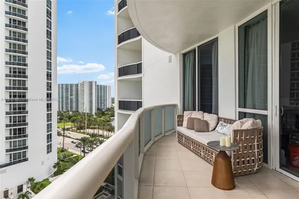 a balcony with furniture and city view
