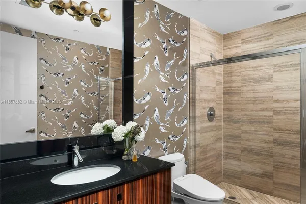 a bathroom with a sink toilet and shower