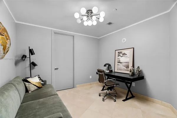 a view of a workspace with furniture and a chandelier fan