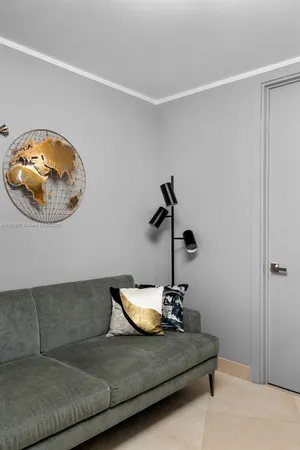 a living room with a couch and a chandelier