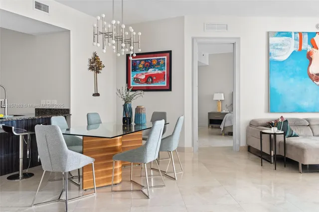 a view of a dining room with furniture and chandelier