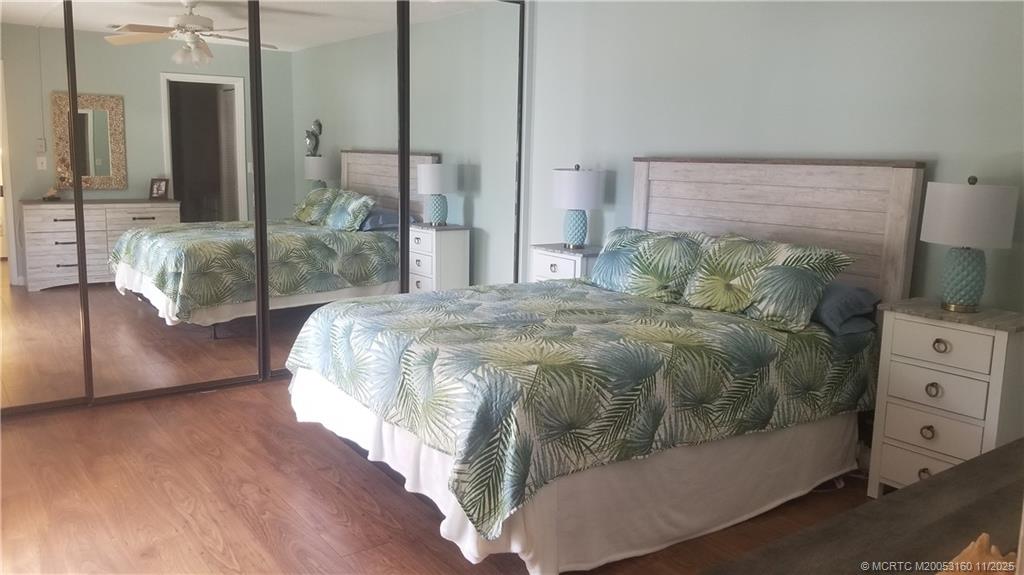 3828 Jefferson Street Stuart, FL 34997 - Photo 11 of 15 a bedroom with a large bed and a chandelier
