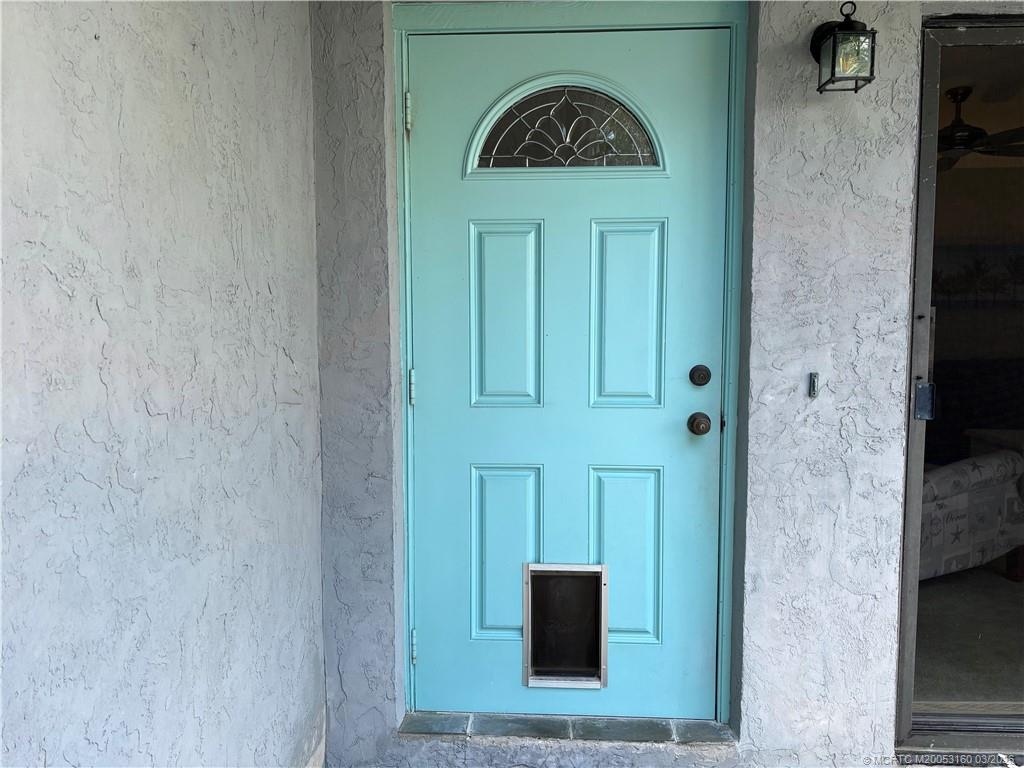 3828 Jefferson Street Stuart, FL 34997 - Photo 13 of 19 a front view of a house with entryway
