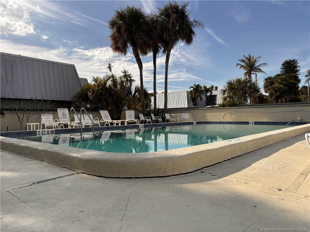3828 Jefferson Street Stuart, FL 34997 - Photo 14 of 15 a view of swimming pool with outdoor seating and plants