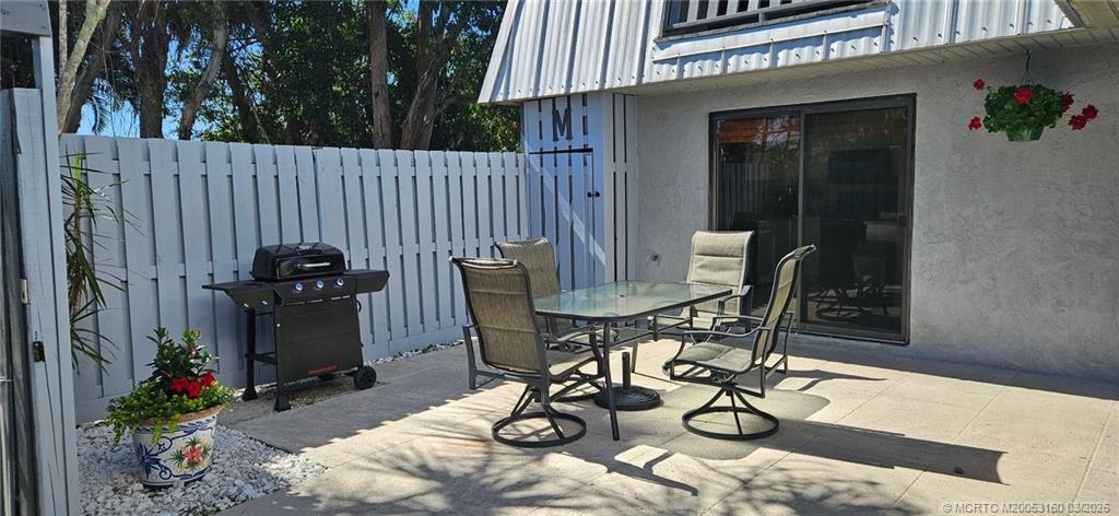 3828 Jefferson Street Stuart, FL 34997 - Photo 17 of 19 a view of a dinning table and chairs in patio