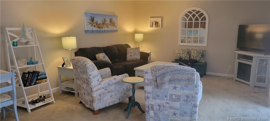 3828 Jefferson Street Stuart, FL 34997 - Photo 6 of 19 a living room with furniture a flat screen tv and a fireplace