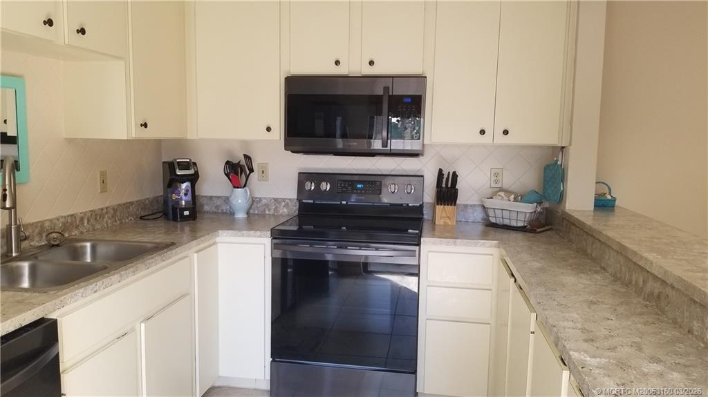 3828 Jefferson Street Stuart, FL 34997 - Photo 7 of 19 a kitchen with a sink and a stove top oven