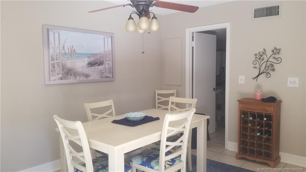 3828 Jefferson Street Stuart, FL 34997 - Photo 8 of 19 a view of a dining room with furniture wooden floor and a chandelier