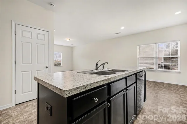 a utility room with a sink and a window