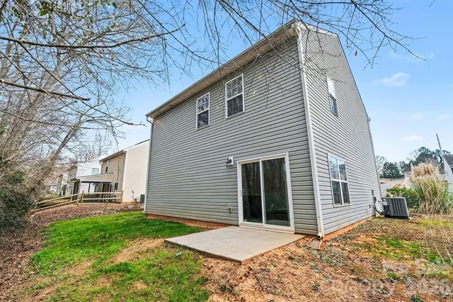 a backyard of a house with garden and barbeque oven