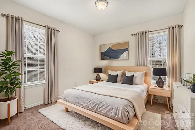a bedroom with a large bed and a potted plant