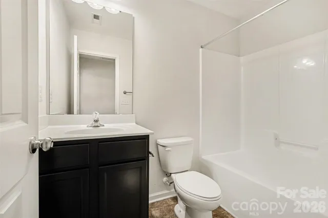 a bathroom with a sink toilet vanity and shower