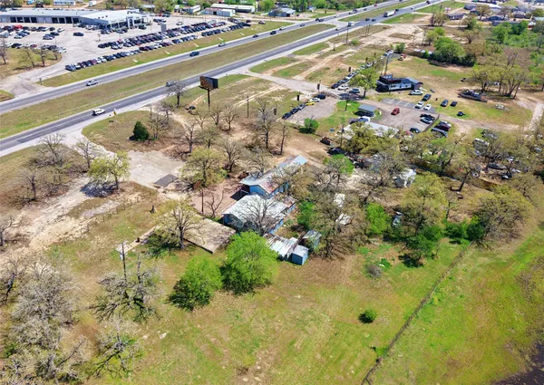 an aerial view of a house with a yard