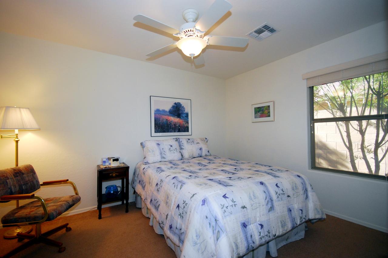 2043 West Tanner Ranch Road Queen Creek, AZ 85144 - Photo 12 of 18 a bedroom with a bed and a large window