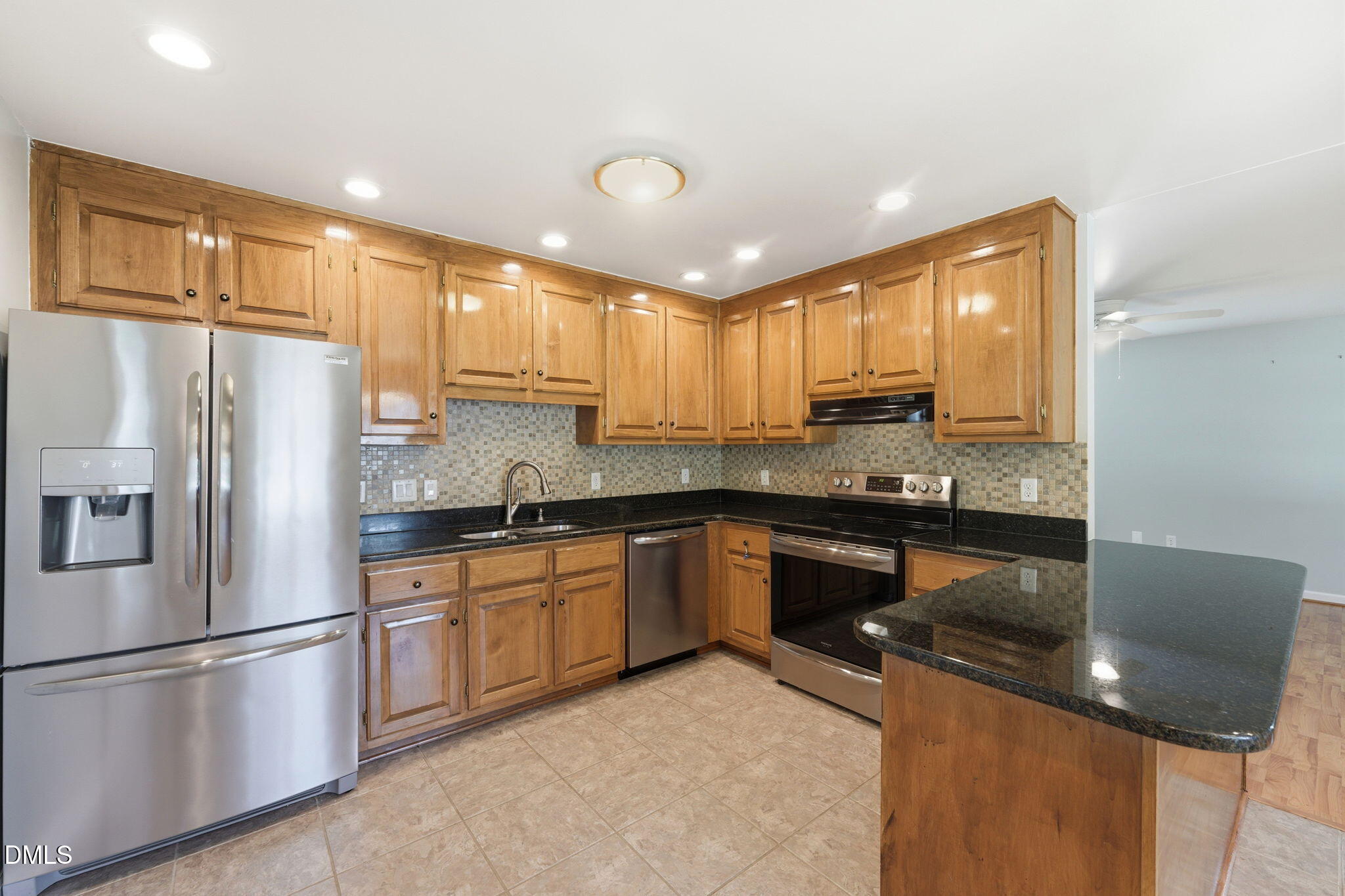 812 East Stagecoach Road Mebane, NC 27302 - Photo 8 of 25 a kitchen with granite countertop kitchen island stainless steel appliances a refrigerator a sink a stove a microwave a center island and cabinets