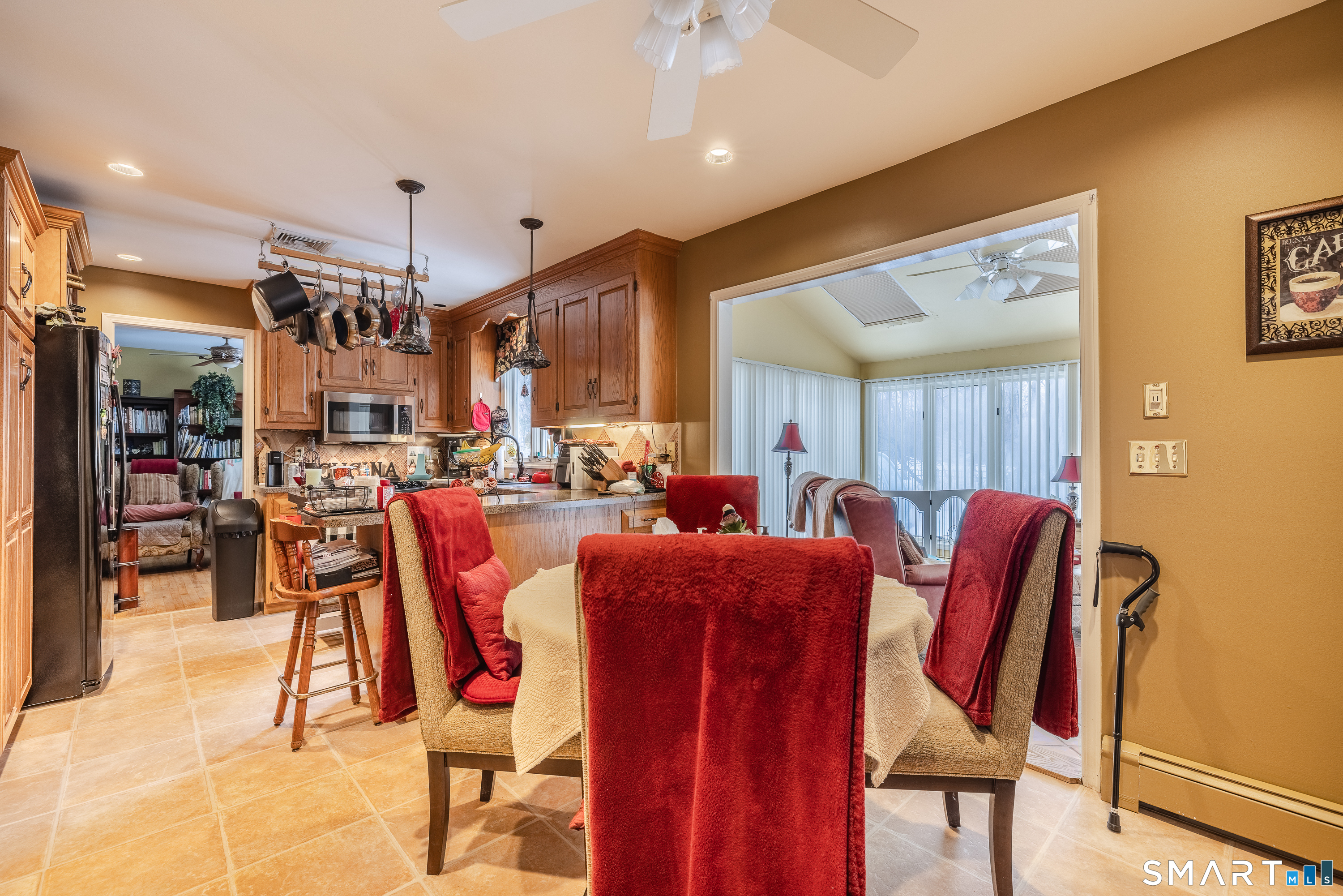 34 Bagburn Hill Road Monroe, CT 06468 - Photo 3 of 28 a living room with furniture a flat screen tv and a dining table
