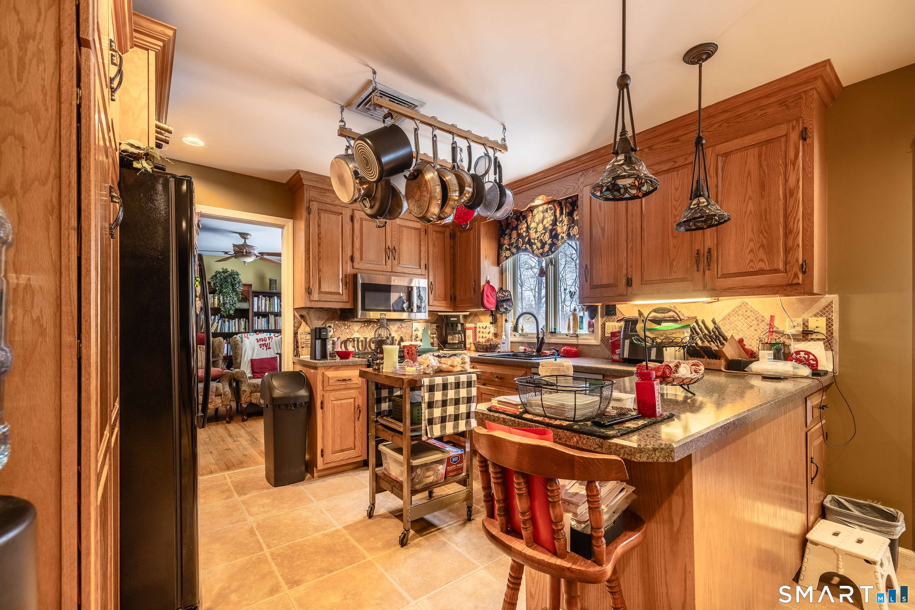 34 Bagburn Hill Road Monroe, CT 06468 - Photo 4 of 28 a view of a dining room with furniture a chandelier and kitchen view