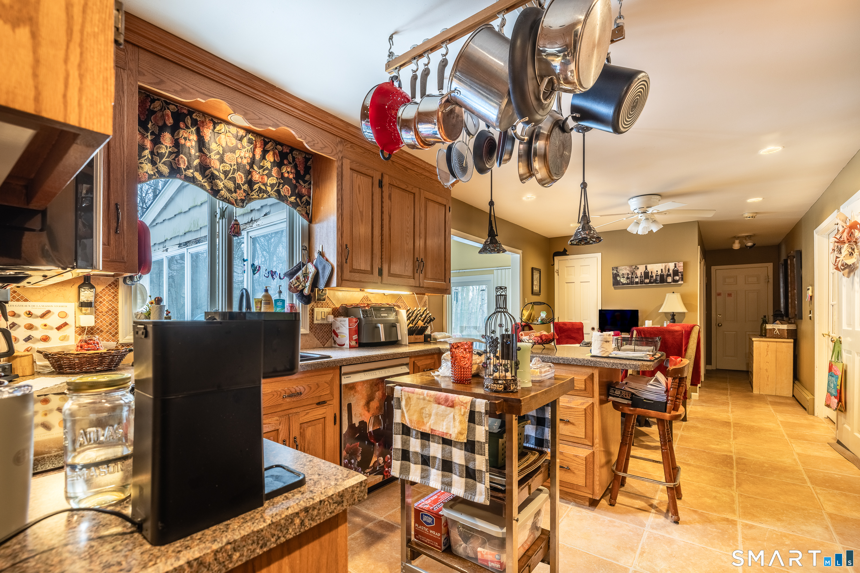 34 Bagburn Hill Road Monroe, CT 06468 - Photo 6 of 28 a view of a dining room with furniture a chandelier and kitchen view