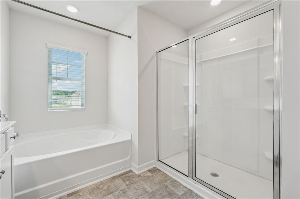 96 Quail Bend Way Dallas, GA 30157 - Photo 24 of 57 a bathroom with a bathtub and a shower