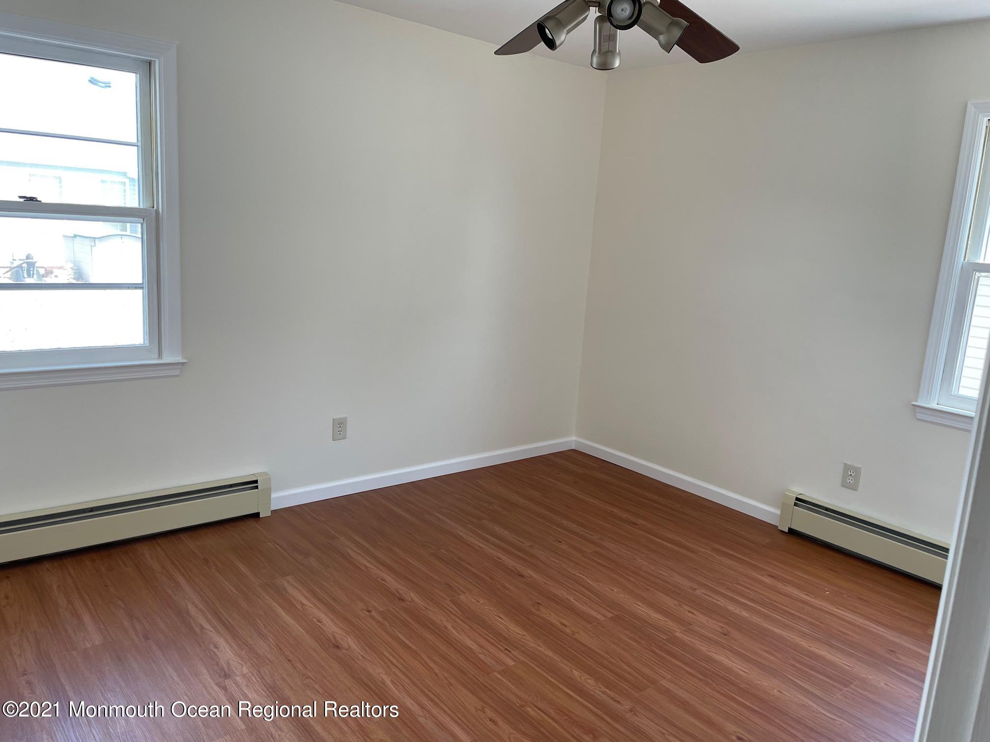 4 Sheridan Road Toms River, NJ 08757 - Photo 12 of 16 wooden floor in an empty room with a window