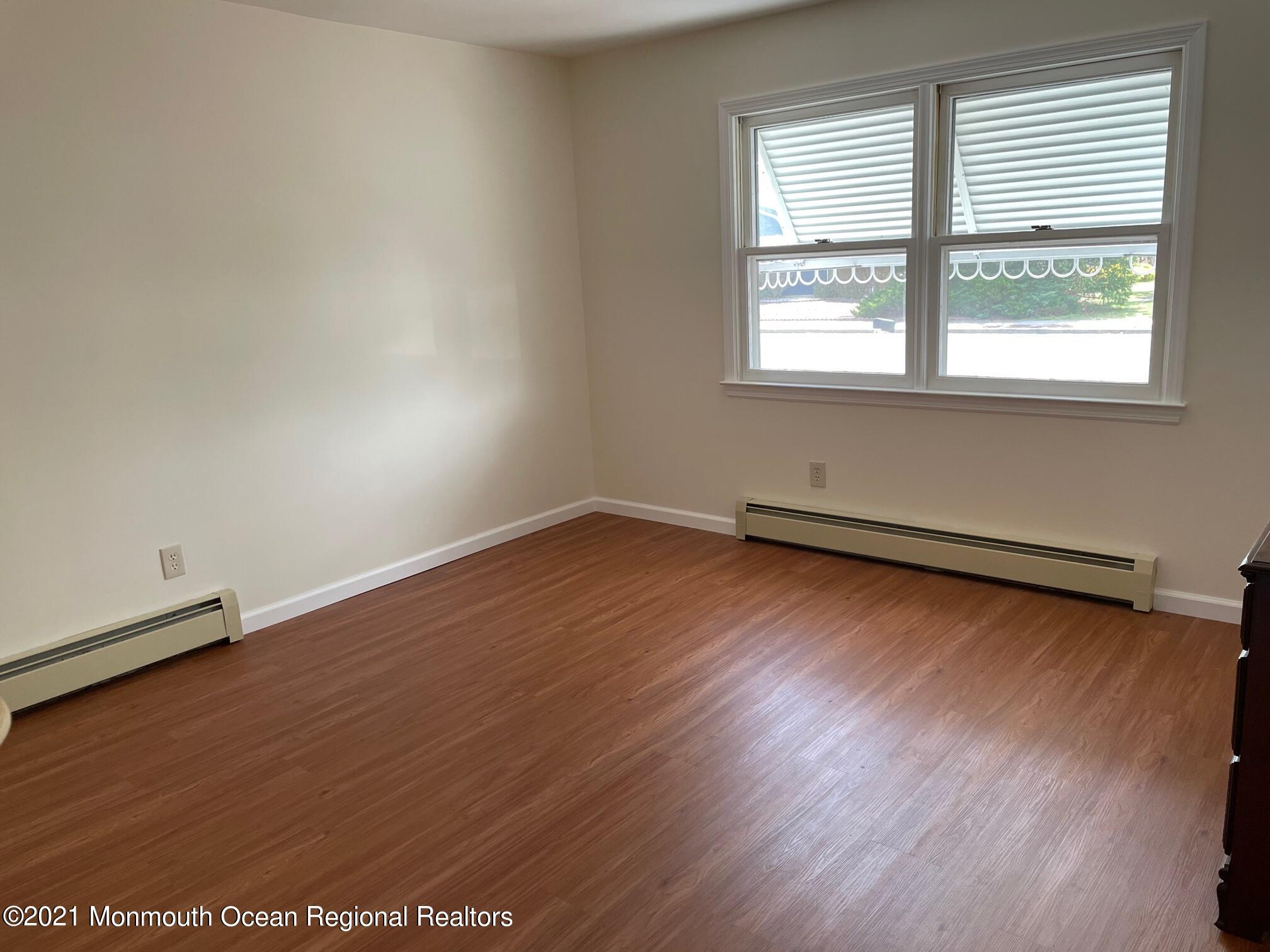 4 Sheridan Road Toms River, NJ 08757 - Photo 15 of 16 an empty room with wooden floor and windows