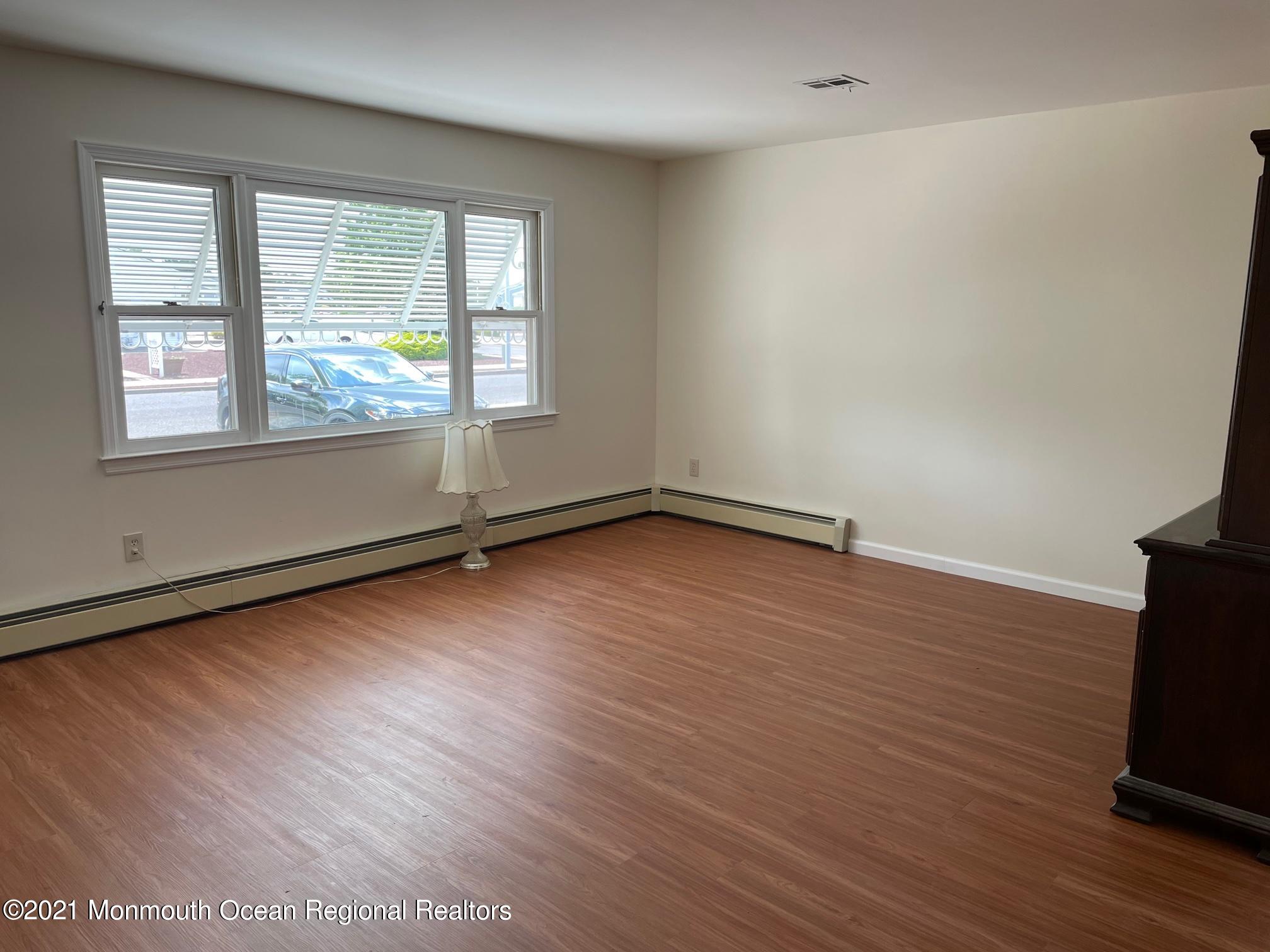 4 Sheridan Road Toms River, NJ 08757 - Photo 4 of 16 an empty room with wooden floor and windows