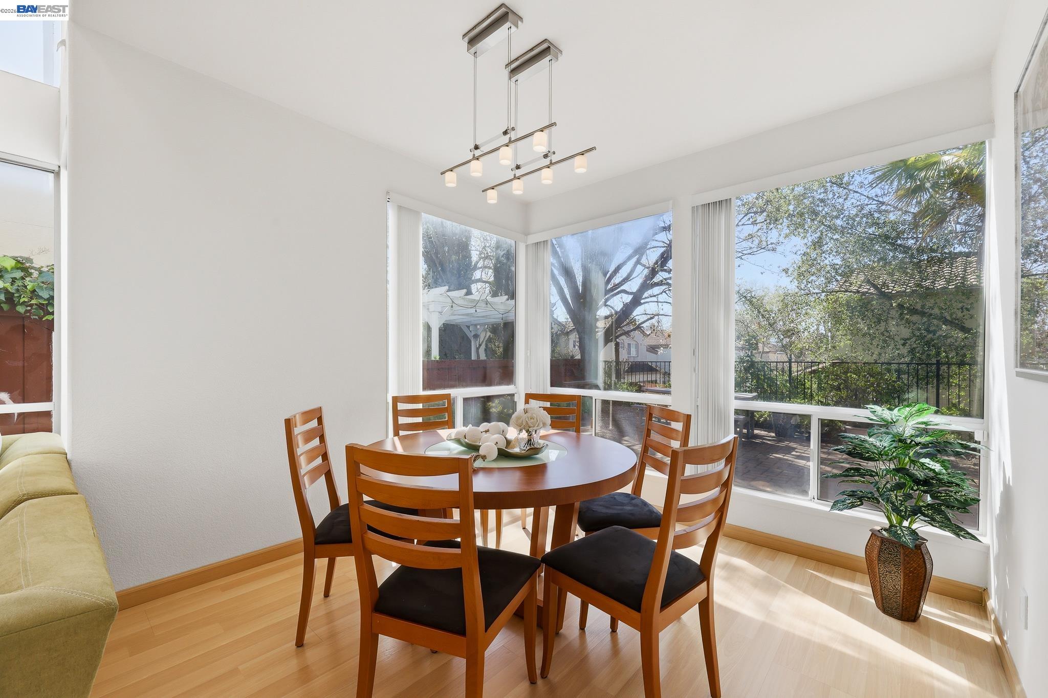 906 Vista Pointe Drive San Ramon, CA 94582 - Photo 17 of 60 a dining room with furniture potted plants and wooden floor